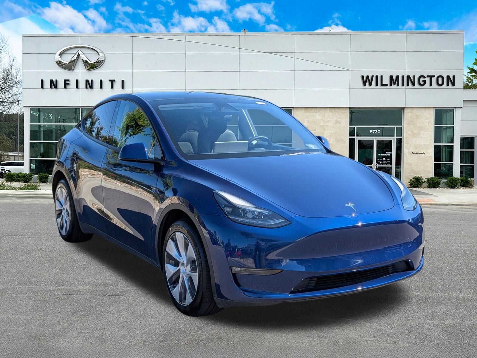 2023 Tesla Model Y Long Range in Deep Blue Metallic — front three-quarter view